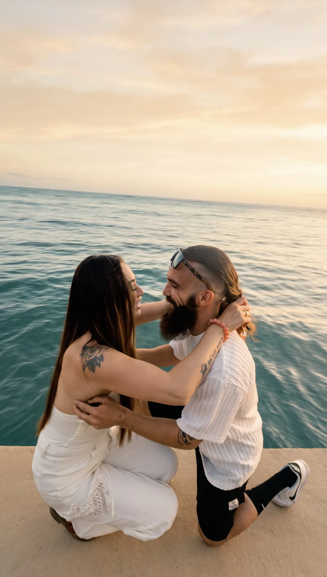 Megan and Gage embracing by the water just after the proposal